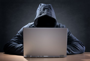 Shutterstock / Brian A. Jackson - Computer hacker stealing data from a laptop concept for network security, identity theft and computer crime